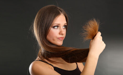 Beautiful Woman Holding Split Ends Of Her Long Hair,