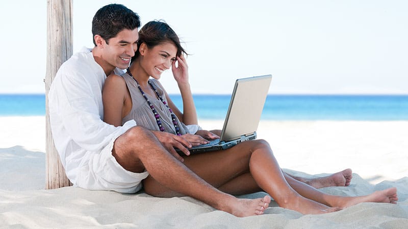 Summer couple using laptop