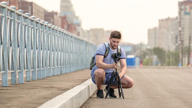 Man with camera on tripod