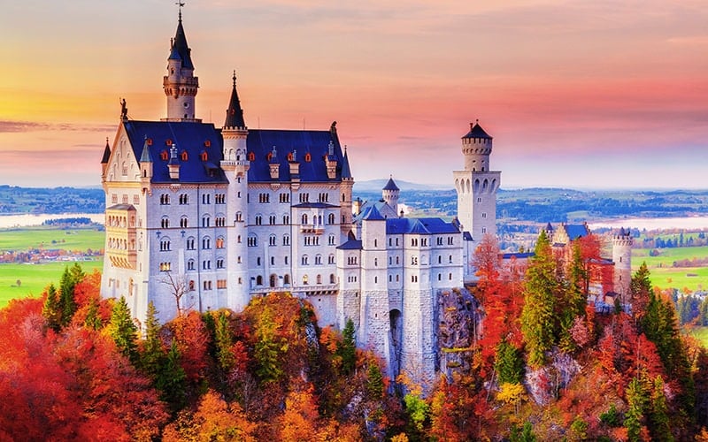 Germany. Famous Neuschwanstein Castle In The Background Of Trees