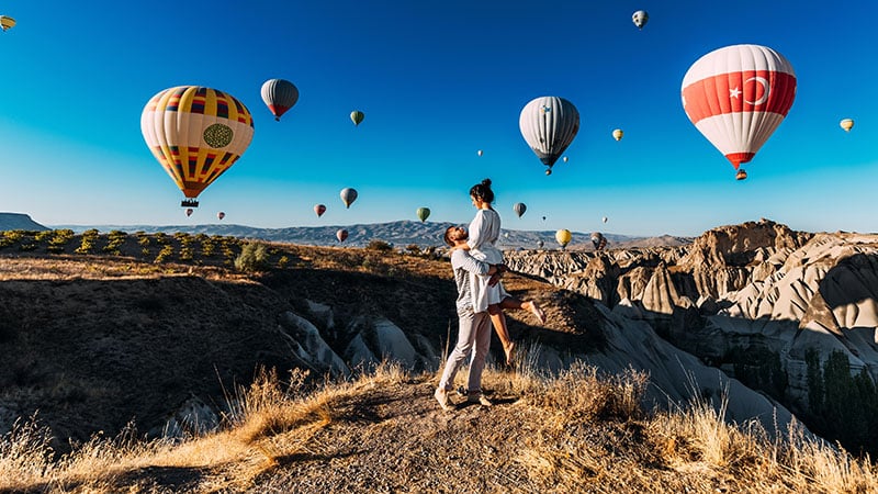Happy Couple In Cappadocia. The Man Proposed To The Girl. Honeym