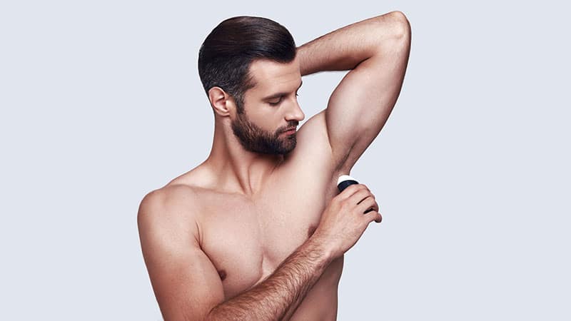 Fresh All Day Long. Handsome Young Man Applying Deodorant While