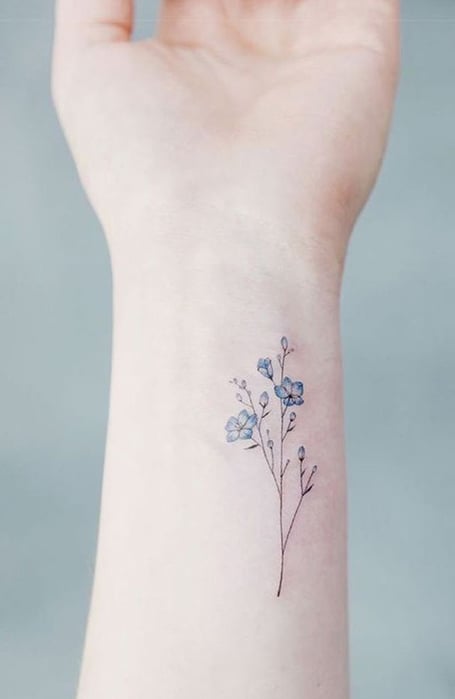 Subtle forgetmenot flower tattoo on the wrist