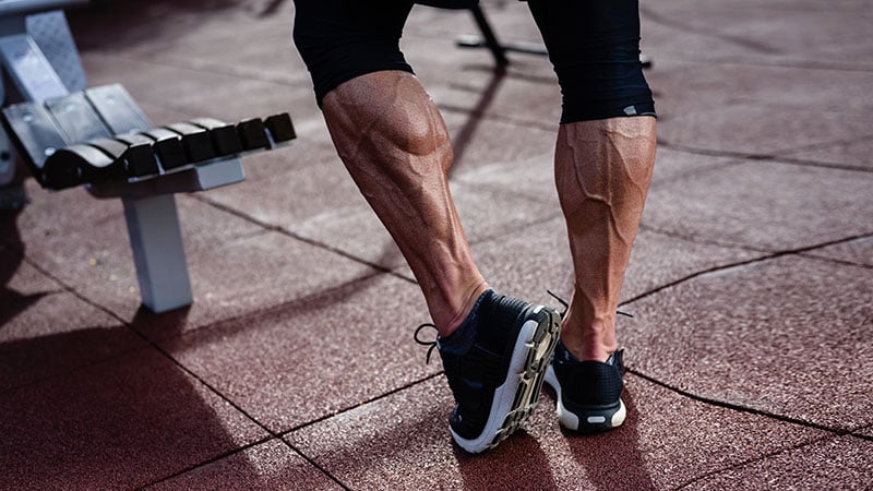 Strong Athlete Active Legs Of Man In Sneakers On Outdoor Training Workout Sport Street Gym In Summer