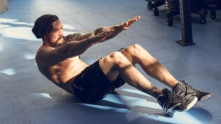 Handsome Muscular Man Doing Sit Ups On Gym Floor