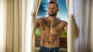 Muscular Topless Man Standing By Window
