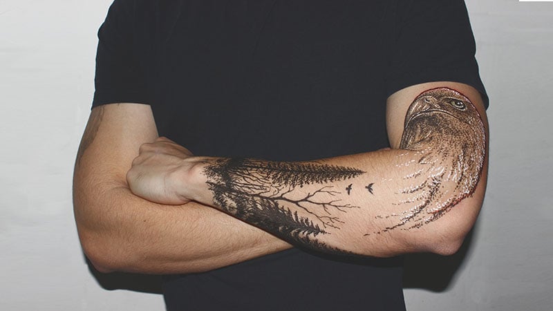 Black tree tattoo on the left forearm - Tattoogrid.net