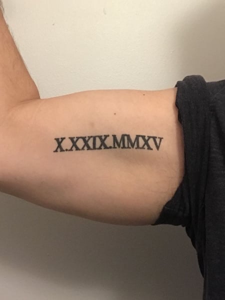 Roman numerals lettering tattoo on the wrist