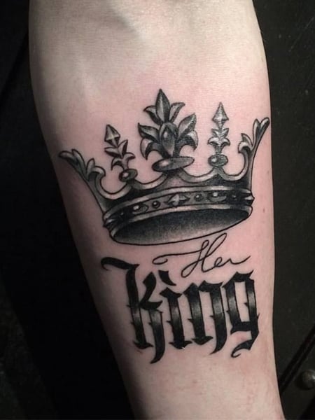 Crown tattoo on the inner forearm.