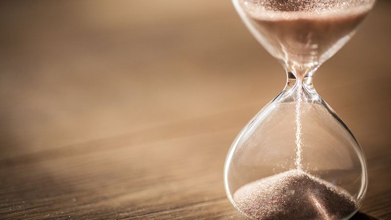 Sand Running Through The Bulbs Of An Hourglass Measuring The Pas
