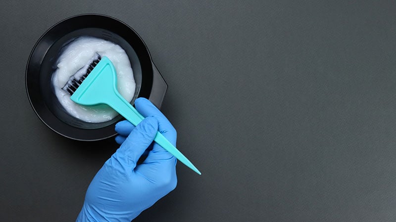 Barber Mixes The Hair Dye With A Brush In A Bowl