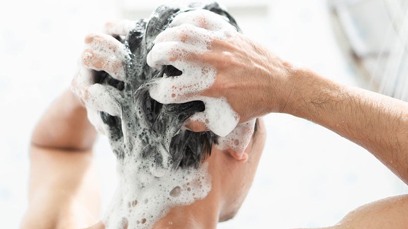 Closeup Young Man Washing Hair With With Shampoo In The Bathroom