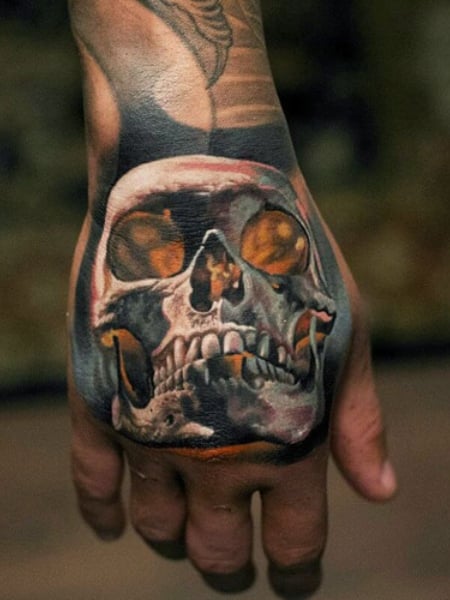 Horror tattoo located on the hand black and grey