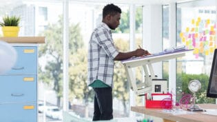 Male Executive Working Over Drafting Table