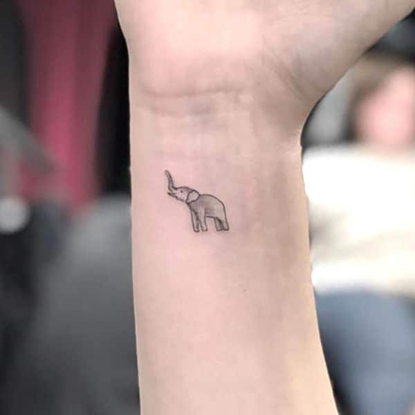 Tiny minimalistic elephant tattoo placed on the finger