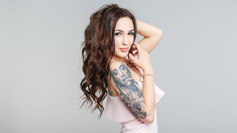 Beautiful Young Woman With Stylish Tattoo On Hand In Pink Dress