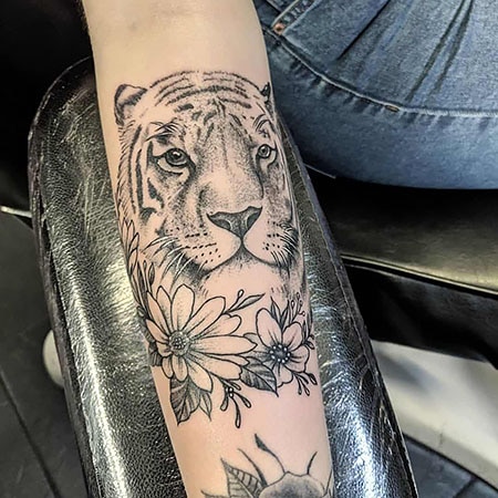 Tattoo uploaded by Sergio Fernandez  Tiger with flowers Inner forearm   Tattoodo