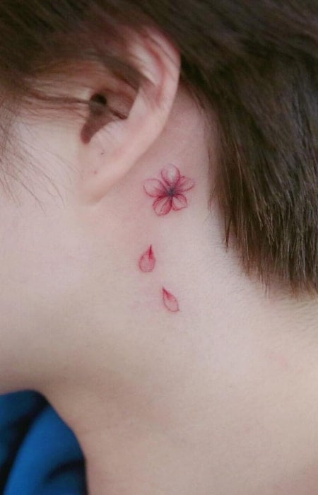 Cherry blossom cover up tattoo located behind the ear