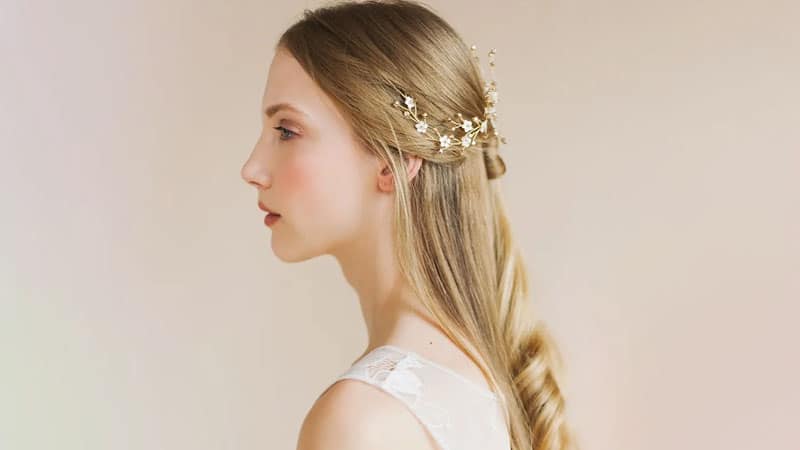 Image of Half up half down hairstyle with a barrette to draw