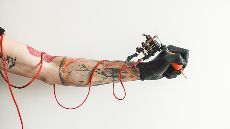 Hand Tattoo Artist With The Tattoo Machine