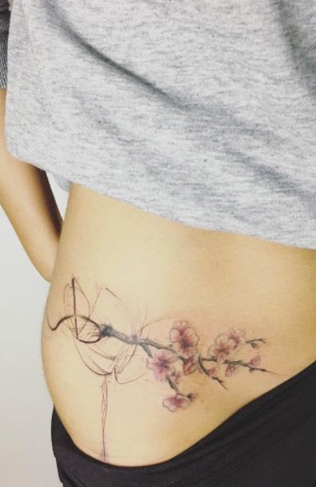 Minimalistic style Venus symbol tattooed on the pelvis