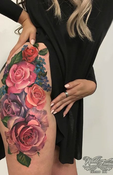 Delicate fine line rose tattoo placed on the hip