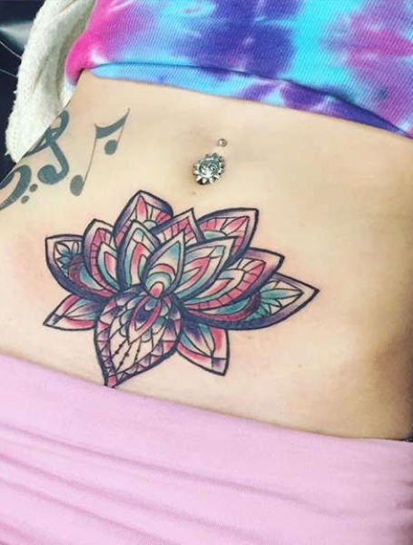 Rose tattoos on the stomach and hip hiding a skar