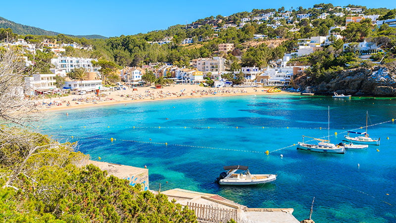 Fishing And Sailing Boats On Blue Sea Water In Cala Vadella Bay,