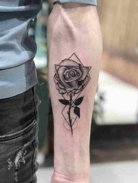Small rose tattoo behind the left ear