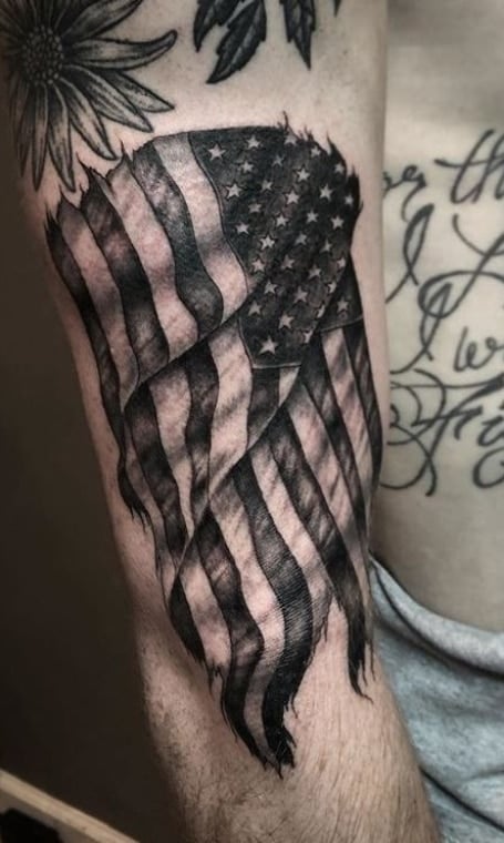 American flag tattoo in photo realism black and white  American flag tattoo  Patriotic tattoos American flag sleeve tattoo