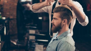 Profile View Of A Red Bearded Stylish Barber Shop Client. He Is