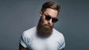 Stylish Young Hipster With A Long Beard Wearing Sunglasses
