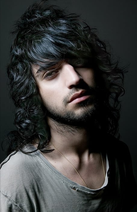 Long Curly Hair With Swooping Fringe Emo Hairstyle for men