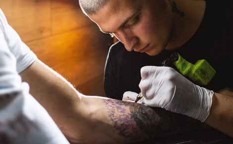 Tattoo Artist Making A Tattoo On A Hand In Tattoo Studio